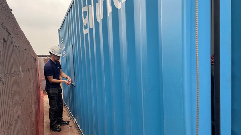 Heisco a man outside a container-mod.jpg